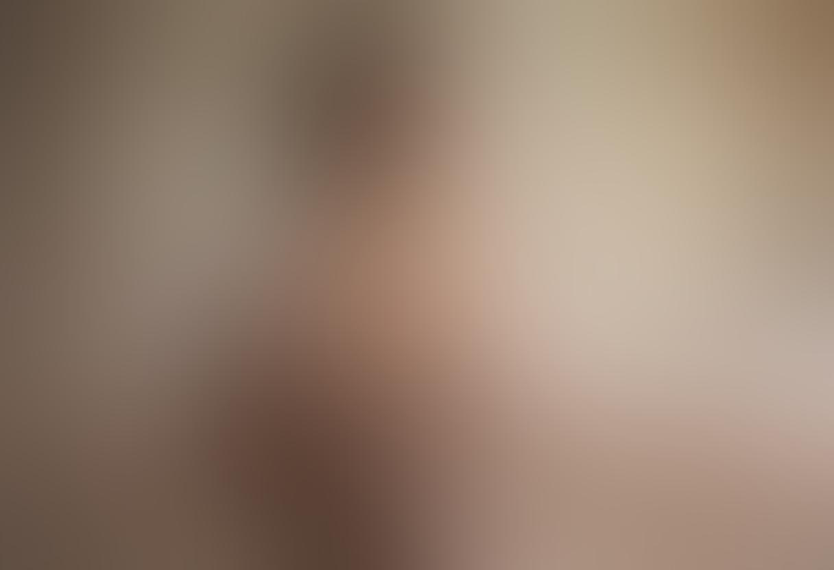 An elegant artistic nude figure gracefully draped in sheer fabric, surrounded by soft, ethereal lighting that emphasizes the contours of the body. Incorporate elements of nature, like delicate flowers and flowing water, to symbolize intimacy and connection. The background should be blurred to focus on the figure, creating a serene atmosphere. Capture the essence of vulnerability and beauty with a harmonious color palette. super-realistic. soft focus. ethereal lighting.